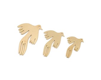 May include: Three gold-colored bird-shaped decorations in varying sizes. Each bird has outstretched wings and a long, stylized tail. The birds are set against a plain white background.