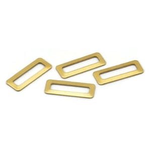 May include: Four gold-colored metal rectangle-shaped rings with a hole in the center. These rings are commonly used for jewelry making or crafting.