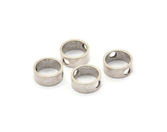 May include: Four silver metal rings with two holes each. The rings are smooth and have a slightly textured surface.