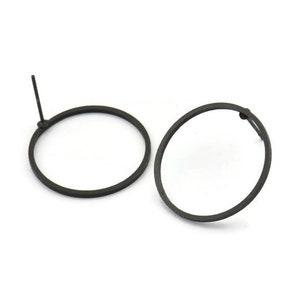 May include: A pair of black hoop earrings. The earrings are simple and minimalist in design, with a smooth, circular shape.