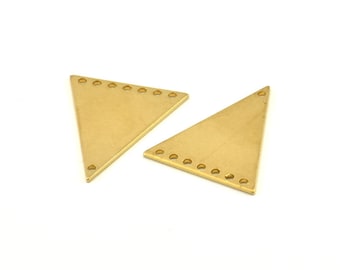 May include: Two gold-colored triangle-shaped metal pieces with holes around the edges.