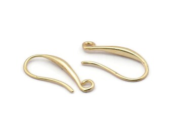 May include: Two gold-toned earring hooks. The hooks are made of metal and have a smooth, curved design.