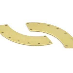 May include: Two gold-coloured metal half-circle pieces with holes around the edges.