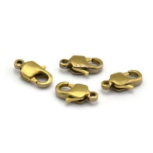 Peut inclure: Quatre fermoirs à langouste dorés, un type de fermoir utilisé pour la fabrication de bijoux.