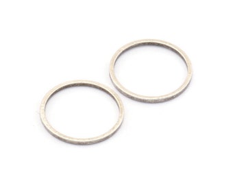 May include: Two silver rings, one slightly larger than the other, are shown on a white background.