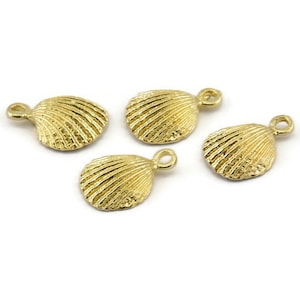 May include: Four gold-coloured metal seashell charms with a loop for attaching to jewellery or other crafts.