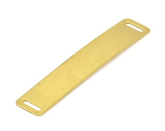 May include: A gold-colored metal tag with two holes for attaching to a collar or other item.