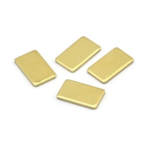 May include: Four rectangular, gold-colored metal components are arranged on a white surface. Each component has a smooth, flat surface and rounded edges. The components are likely jewelry findings or craft supplies.