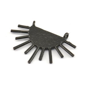 May include: A black metal pendant with a half-circle shape and multiple radiating points, resembling a sunburst.