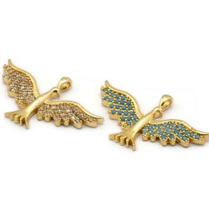 May include: Two gold-tone bird charms with wings adorned with sparkling stones. One charm has clear stones, while the other has turquoise stones.