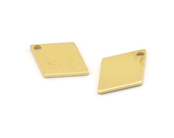 May include: Two gold-coloured metal diamond-shaped charms with a small hole at the top for attaching to jewellery or other crafts.