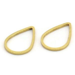 May include: Two gold-colored metal teardrop-shaped pendant blanks. The blanks are hollow and have a smooth, slightly textured surface.