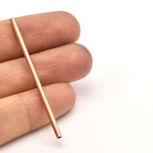 May include: A long, thin, copper tube.