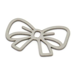 May include: A silver metal charm in the shape of a bow. The bow is a simple outline with no details.