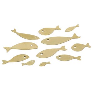 May include: Eleven golden-coloured fish cutouts of varying sizes. Each fish has a rounded body, a tail fin, and a small circular eye. The fish are arranged on a white background.