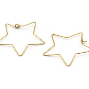 May include: A pair of gold star-shaped hoop earrings. The earrings are made of thin wire and have a simple design.