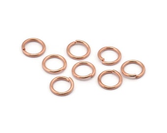 May include: Ten rose gold jump rings, each with a diameter of approximately 6mm. These rings are ideal for jewelry making and crafting.