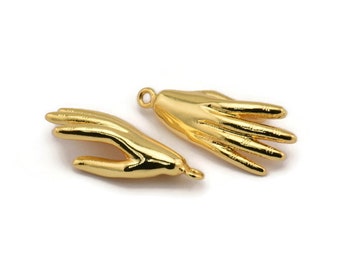 May include: Two gold-toned metal hand charms. One hand is open with fingers spread out, the other hand is closed in a fist.