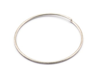 May include: A silver hoop earring with a smooth finish.