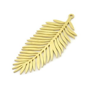 May include: A gold-coloured metal palm leaf charm with a hole at the top for hanging.