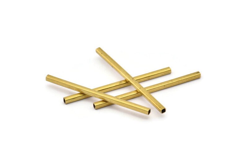 May include: Four gold-coloured metal tubes, each with a square cross-section, are stacked on top of each other.