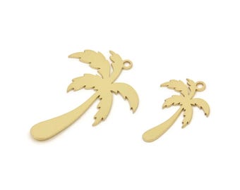 May include: Two gold-colored metal palm tree charms. The larger charm is about 2 inches tall and the smaller charm is about 1 inch tall.