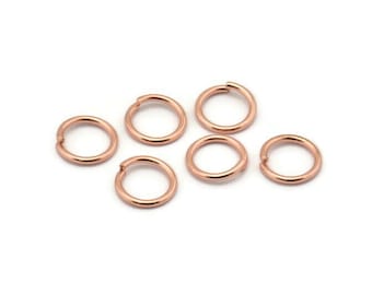 May include: Six rose gold jump rings, each with a diameter of approximately 6mm. These rings are ideal for jewelry making and crafting.
