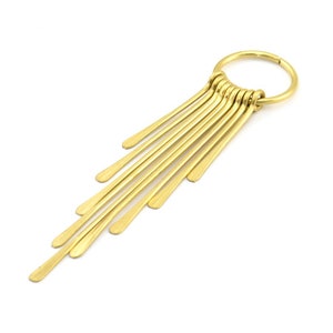 May include: Gold hoop earring with a dangling fringe of thin, flat, gold bars.