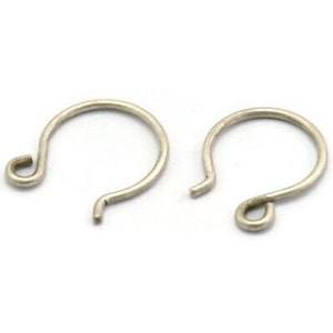 May include: Two silver earring hooks, each with a small loop at the top and a larger loop at the bottom.