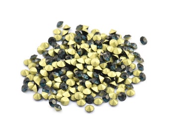 May include: A pile of gold and dark blue rhinestones, perfect for crafting and jewelry making.