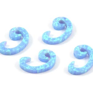 May include: Four light blue opal swirl shaped charms. The charms are in the shape of a spiral with a hook at the end.