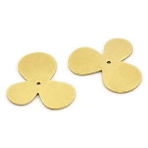 May include: Two gold-colored metal flower charms with three petals each. The charms have a small hole in the center.