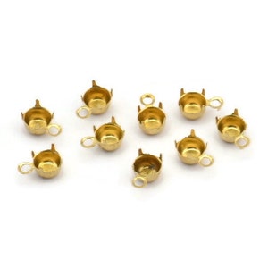 May include: Ten gold-toned metal bead caps with a small loop on the side. The caps are designed to hold a bead in place.