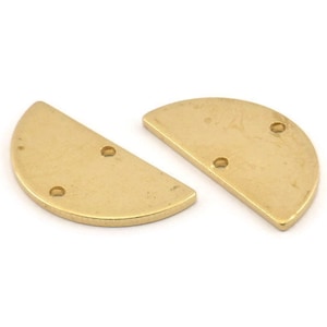 May include: Two gold-colored metal half-circle shapes with three holes each.