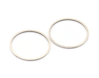 May include: Two silver metal rings, one slightly larger than the other, are shown against a white background.