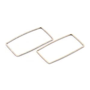 May include: Two silver rectangle hoop earrings. The earrings are simple and modern in design.