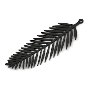 May include: A black palm leaf cutout, a decorative element for crafting or home decor.