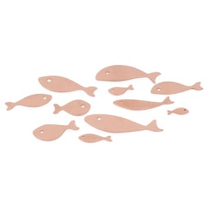 May include: Eleven light brown fish cutouts of different sizes are arranged on a white background. Each fish has a simple, rounded shape with a small hole for an eye. The fish are in a flowing pattern, suggesting movement.