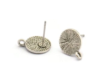 May include: Silver tone earring findings with a round, textured disc and a post for attaching to an earring.