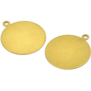 May include: Two gold-colored metal round disc charms with a small loop at the top for attaching to jewelry or other crafts.