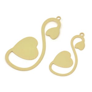 May include: Two gold metal heart-shaped charms with a loop at the top for attaching to jewellery or other crafts.