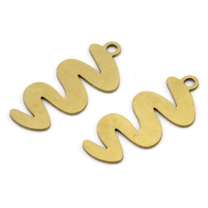 May include: Two gold-colored metal charms shaped like a wavy line. Each charm has a small hole at the top for attaching to a necklace or bracelet.