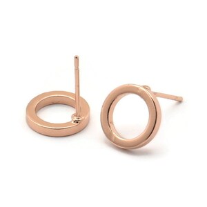May include: A pair of rose gold circle stud earrings. The earrings are simple and elegant, and would make a great gift for any occasion.