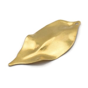 May include: A brass-colored leaf-shaped charm with a textured surface. The charm has a small hole at the top for stringing. The leaf has a gently curved shape and is ideal for jewelry making or other craft projects.