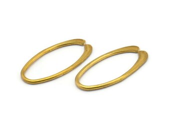May include: A pair of gold oval hoop earrings. The earrings are simple and elegant, and would make a great addition to any jewelry collection.