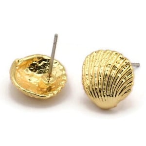 May include: A pair of gold-tone shell-shaped stud earrings. The earrings are made of metal and have a textured surface.