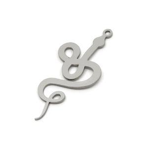 May include: A silver-coloured metal charm in the shape of a stylised snake. The charm has a loop at the top for hanging and features a curved, flowing design. The snake's body has several loops and a pointed tail.