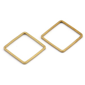 Könnte beinhalten: Zwei goldfarbene quadratische Metallringe. Die Ringe sind offen und haben eine glatte, polierte Oberfläche.