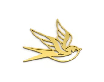May include: A gold-colored metal cutout of a stylized swallow bird in flight.