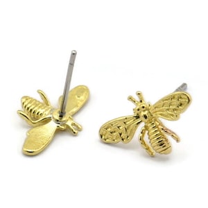 May include: A pair of gold bee stud earrings. The bees are detailed with textured wings and bodies.
